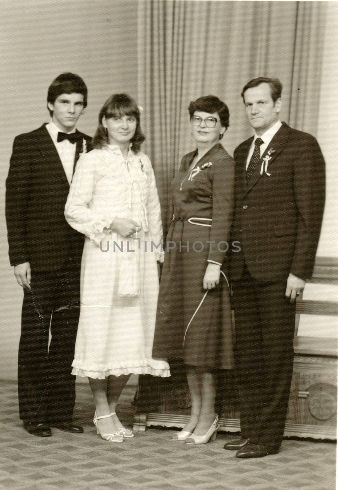 THE CZECHOSLOVAK SOCIALIST REPUBLIC - CIRCA 1980s: Vintage photo shows a bride, bridegroom and parents. Retro black and white photography. Circa 1980.