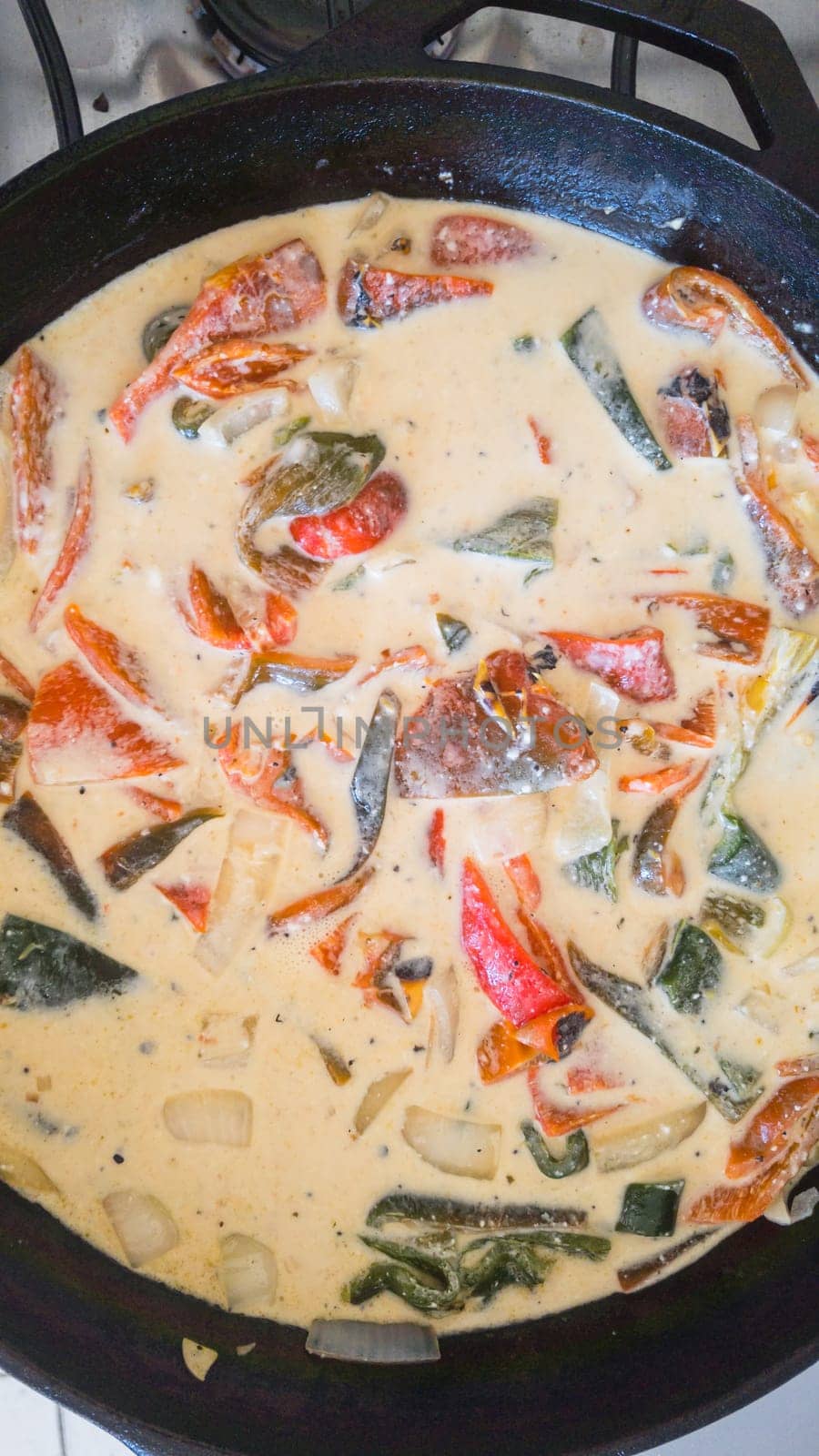 Rajas con crema, poblano chili peppers with cream in cooking pan. Mexican vegetarian food in Baja California.