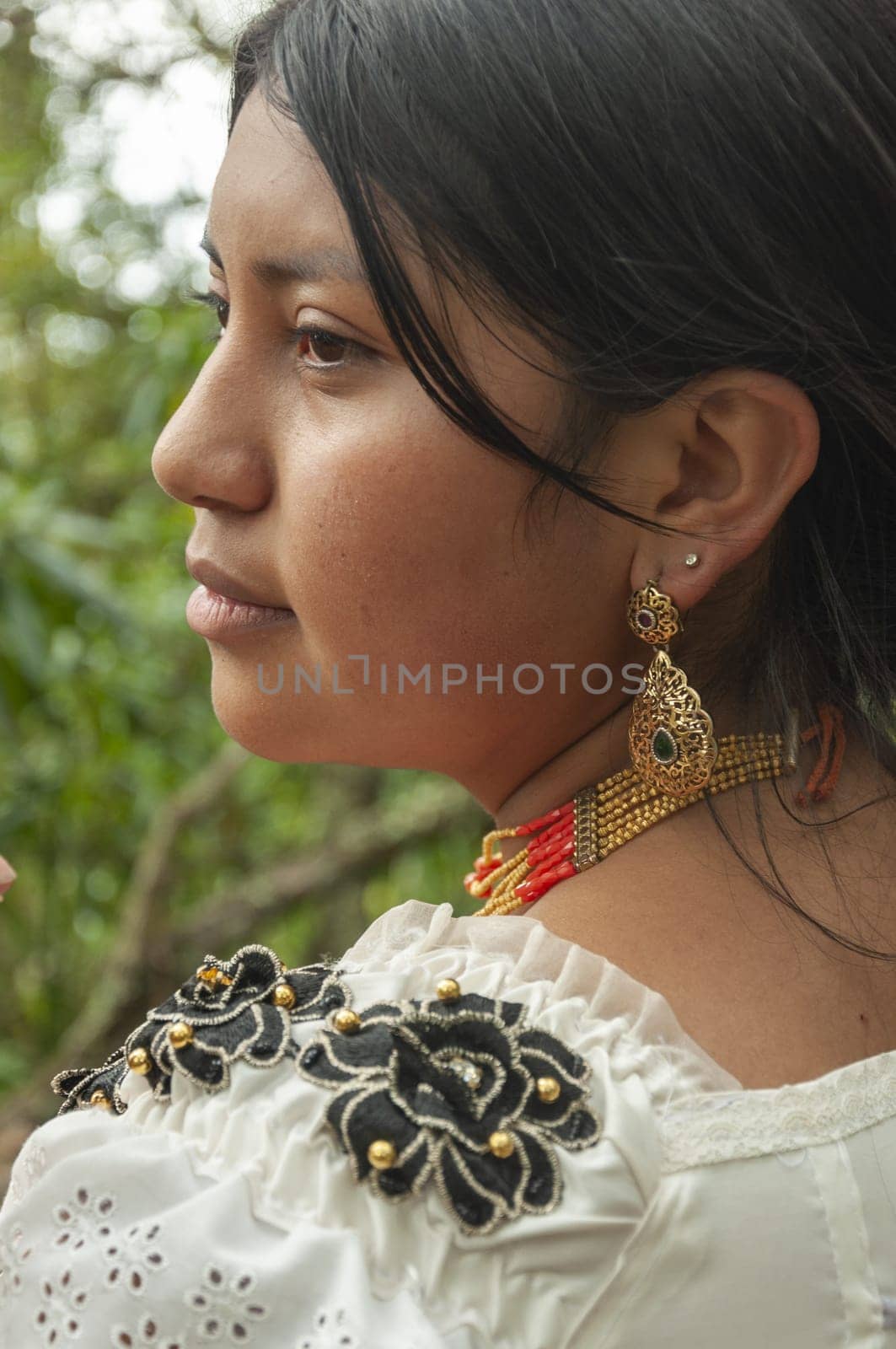 close-up of young indigenous man in the jungle looks in profile. High quality photo