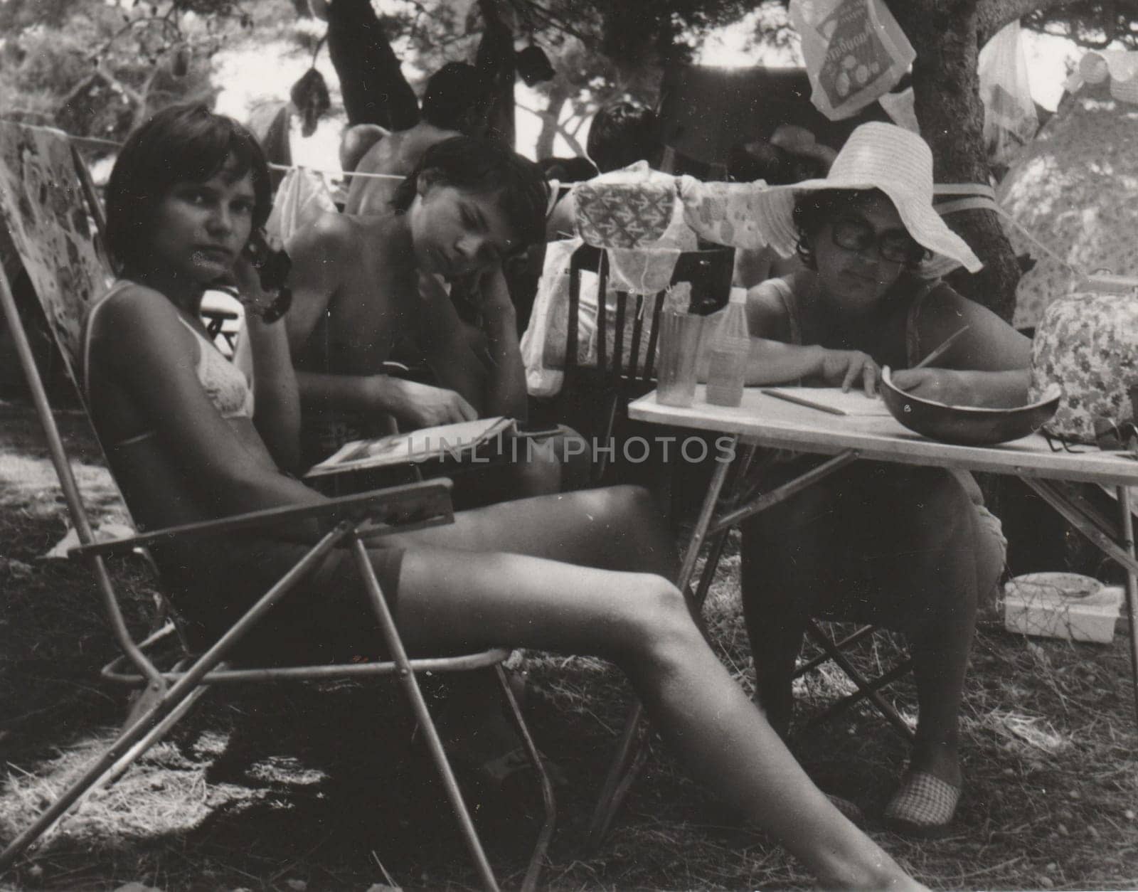 Vintage photo shows people in the summer time. Retro black and white photography. Circa 1980. by roman_nerud