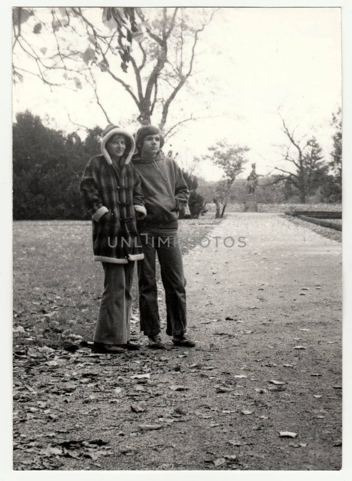 Vintage photo shows teenagers - girl and boy in the autumn - fall. Retro black and white photography. Circa 1980. by roman_nerud