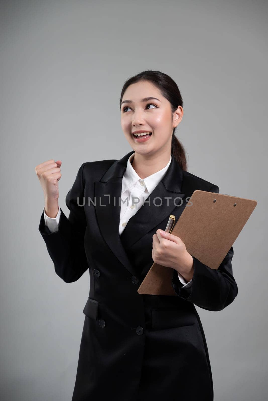 Confident young asian businesswoman making hand gesture. Enthusiastic by biancoblue