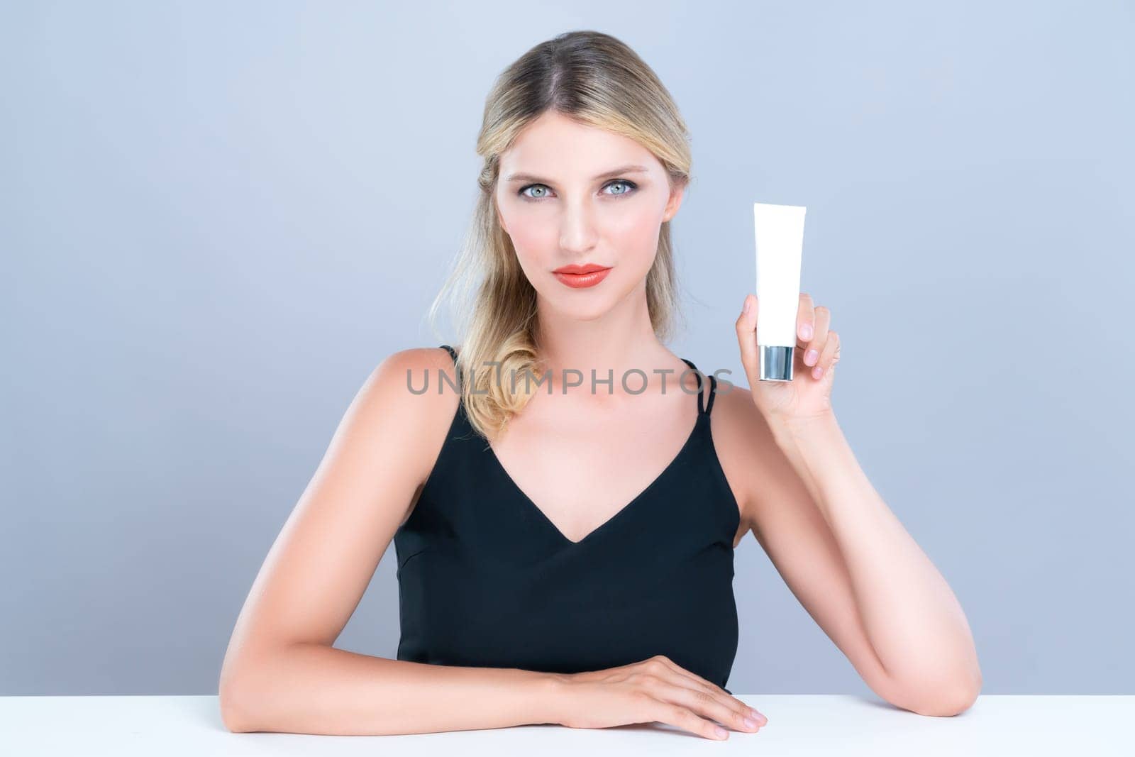 Alluring portrait of perfect skin woman holding mockup moisturizer tube. by biancoblue