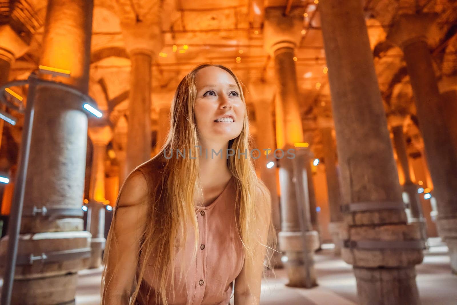 Woman tourist enjoying Beautiful cistern in Istanbul. Cistern - underground water reservoir build in 6th century, Istanbul, Turkey, Turkiye.