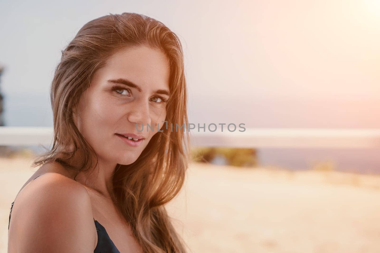 Happy woman portrait in cafe. Boho chic fashion style. Outdoor photo of young happy woman with long hair, sunny weather outdoors sitting in modern cafe