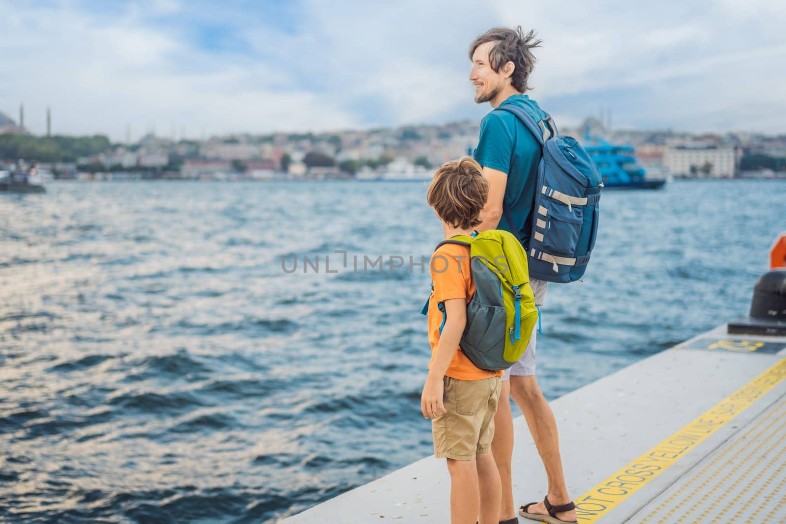 Boy and father tourists enjoying Galataport area view, cruise port of Istanbul newly opening in 2021, located in the shores of the Galata, Karakoy in Istanbul. Traveling with kids concept by galitskaya