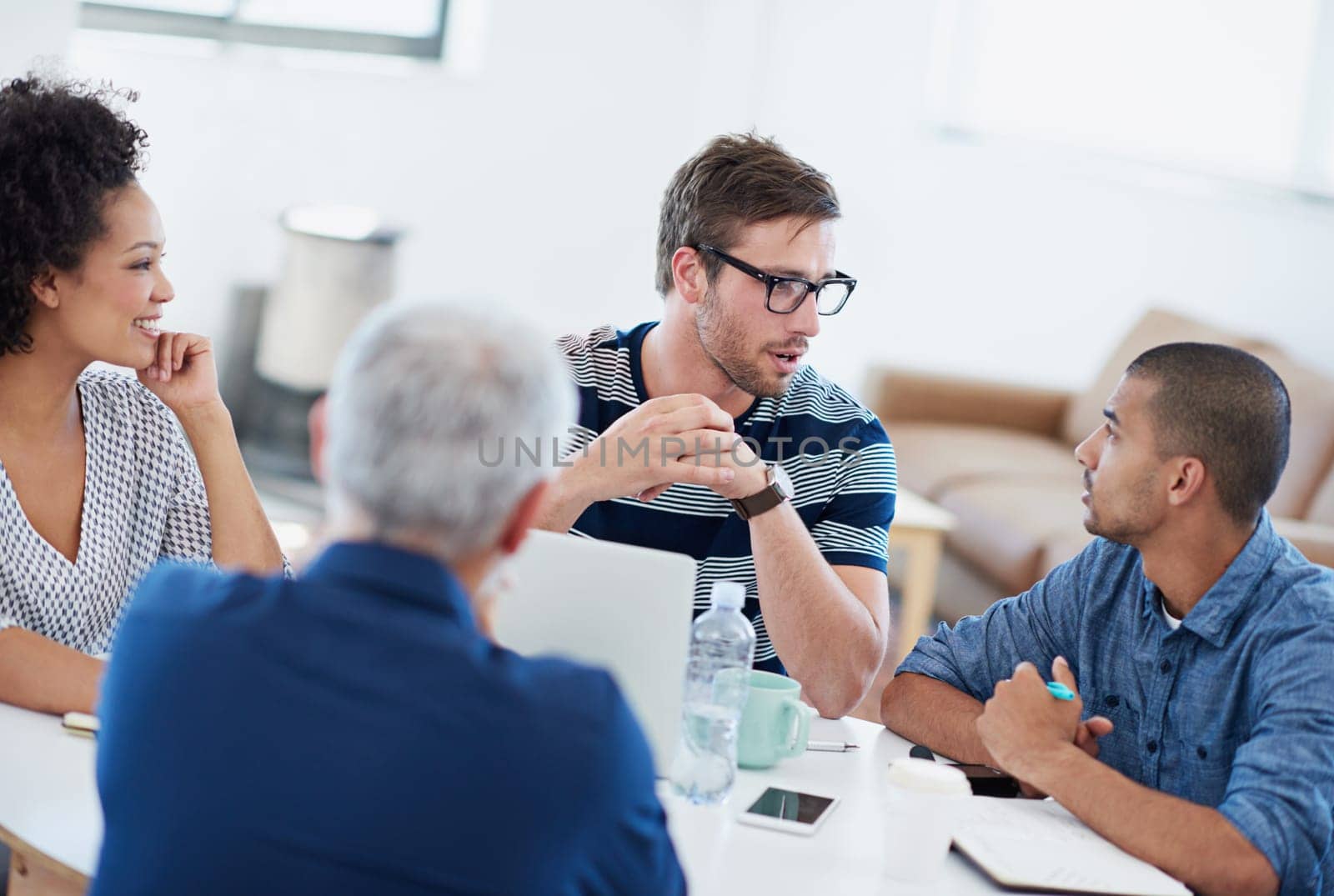 They take everything into account. a group of designers at work in an office