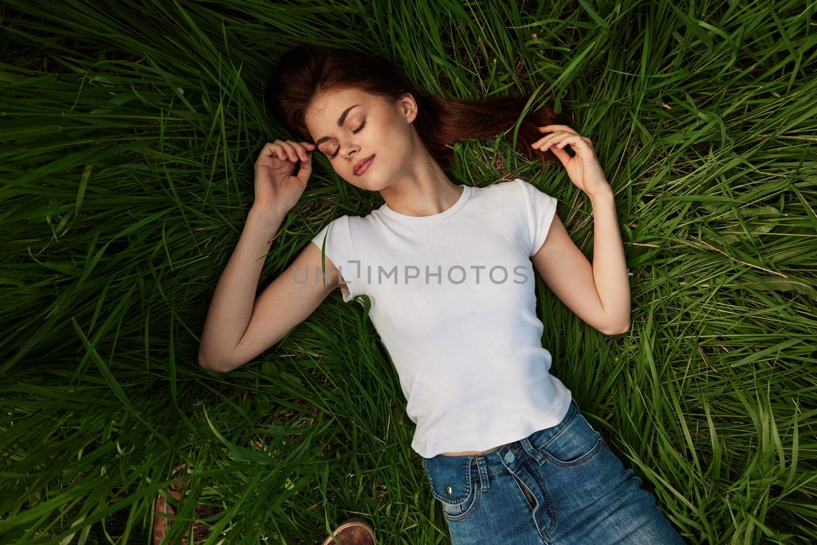 woman dreaming lying on the grass by Vichizh