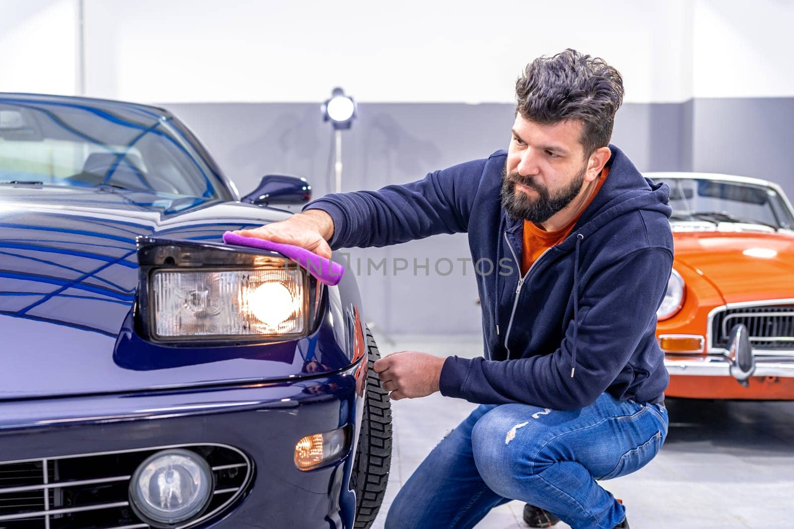 manual cleaning of the exterior of an old car. High quality photo