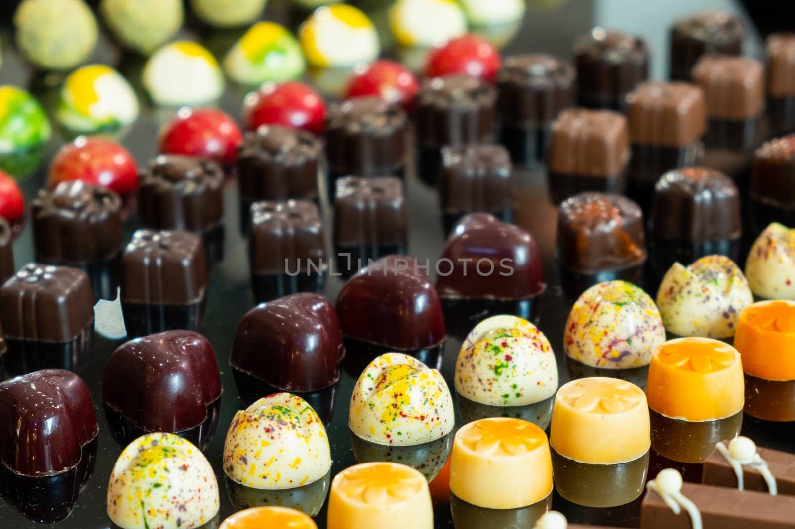 Colorful chocolate candies with different flavors. Exclusive delicious handmade sweets by vladimka
