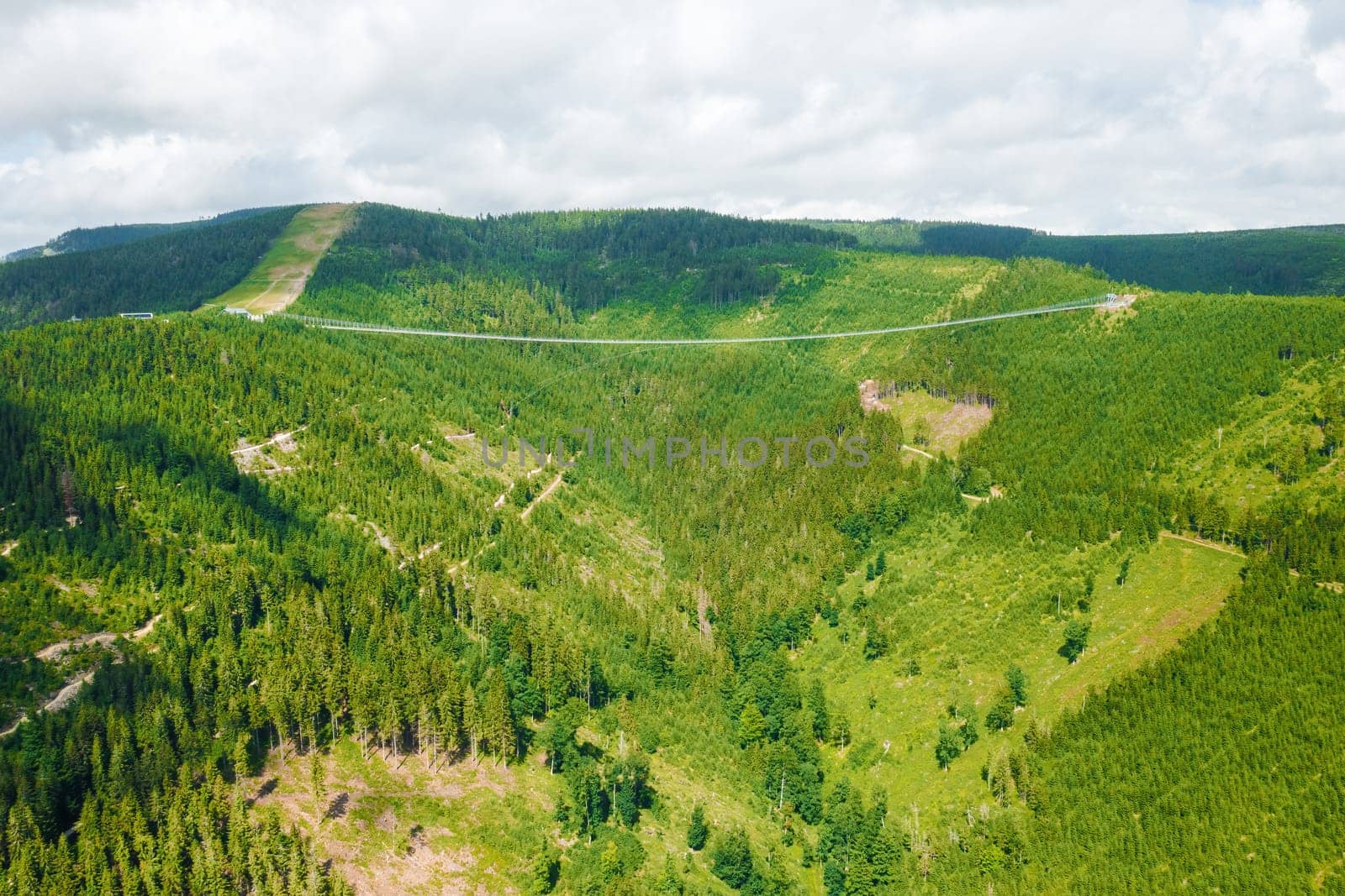 Aerial view of suspension Sky Bridge 721 and observation tower in mountains, Dolni Morava, Czech Republic.