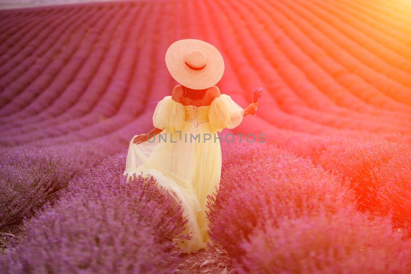 Lavender field happy woman in yellow dress in lavender field summer time at sunset by Matiunina