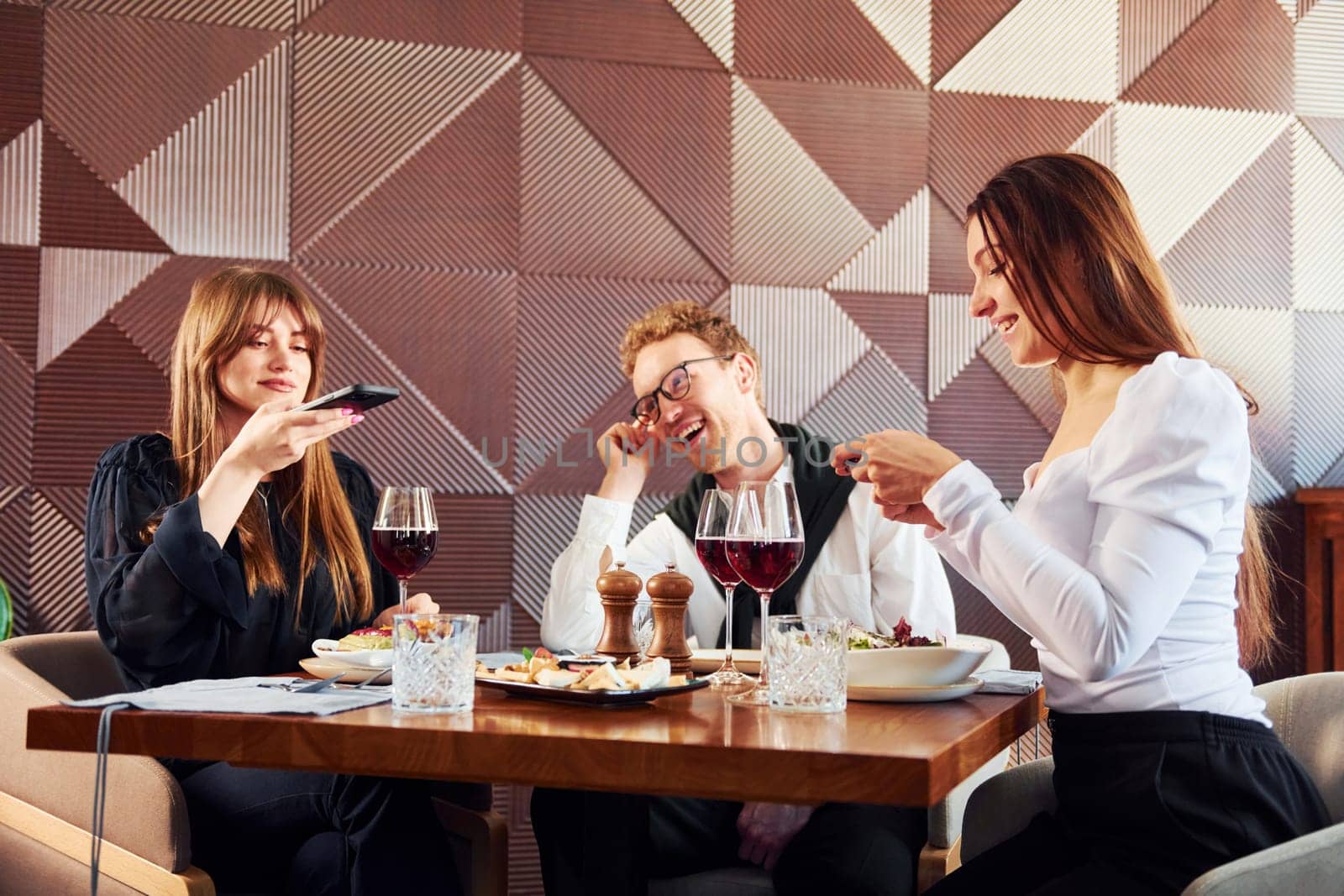 Young couple and mother. Indoors of new modern luxury restaurant.