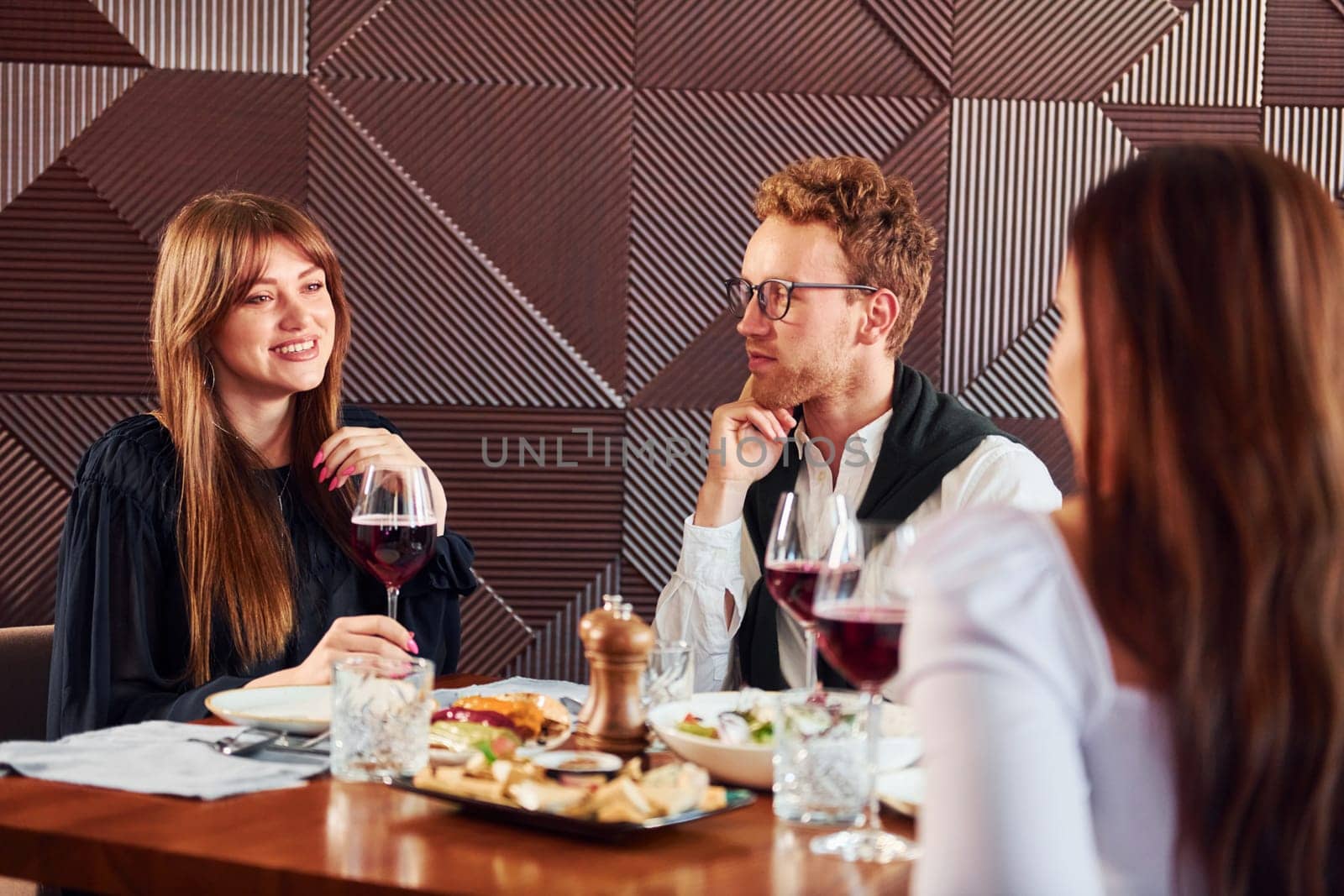 Young couple and mother. Indoors of new modern luxury restaurant.