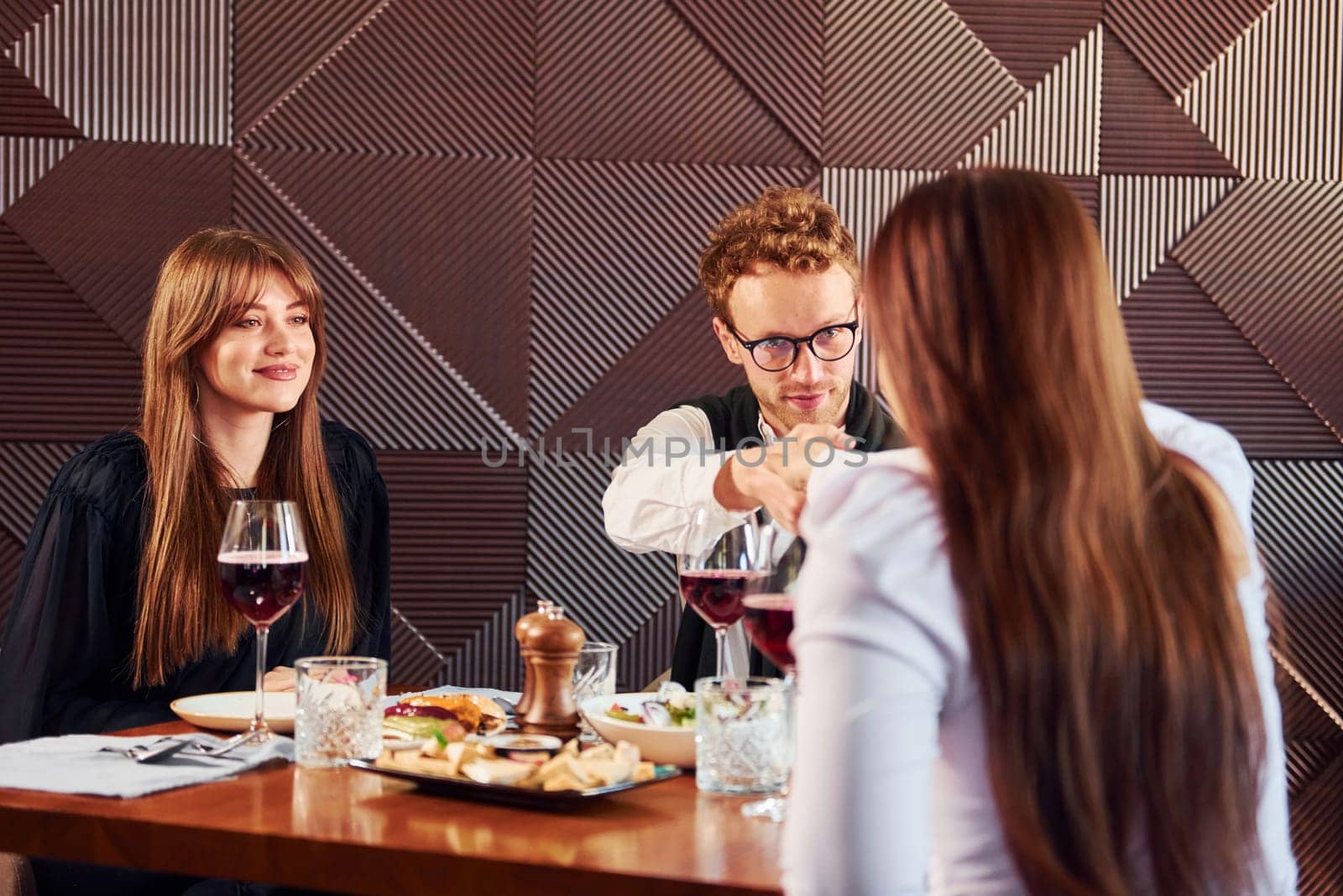 Young couple and mother. Indoors of new modern luxury restaurant.