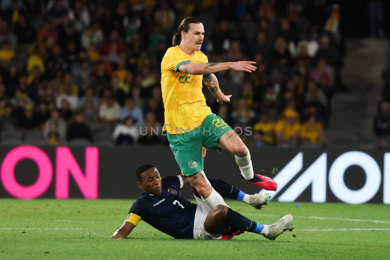 MELBOURNE, AUSTRALIA - MARCH 28: Jackson Irvine of Australia battles with Pervis Estupiñán of Ecuador during an international friendly match between the Australia Socceroos and Ecuador at Marvel Stadium on March 28, 2023 in Melbourne, Australia.