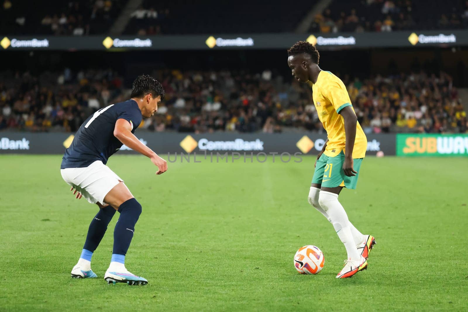 MELBOURNE, AUSTRALIA - MARCH 28: Garang Kuol of Australia battles with Jose Cifuentes of Ecuador during an international friendly match between the Australia Socceroos and Ecuador at Marvel Stadium on March 28, 2023 in Melbourne, Australia.