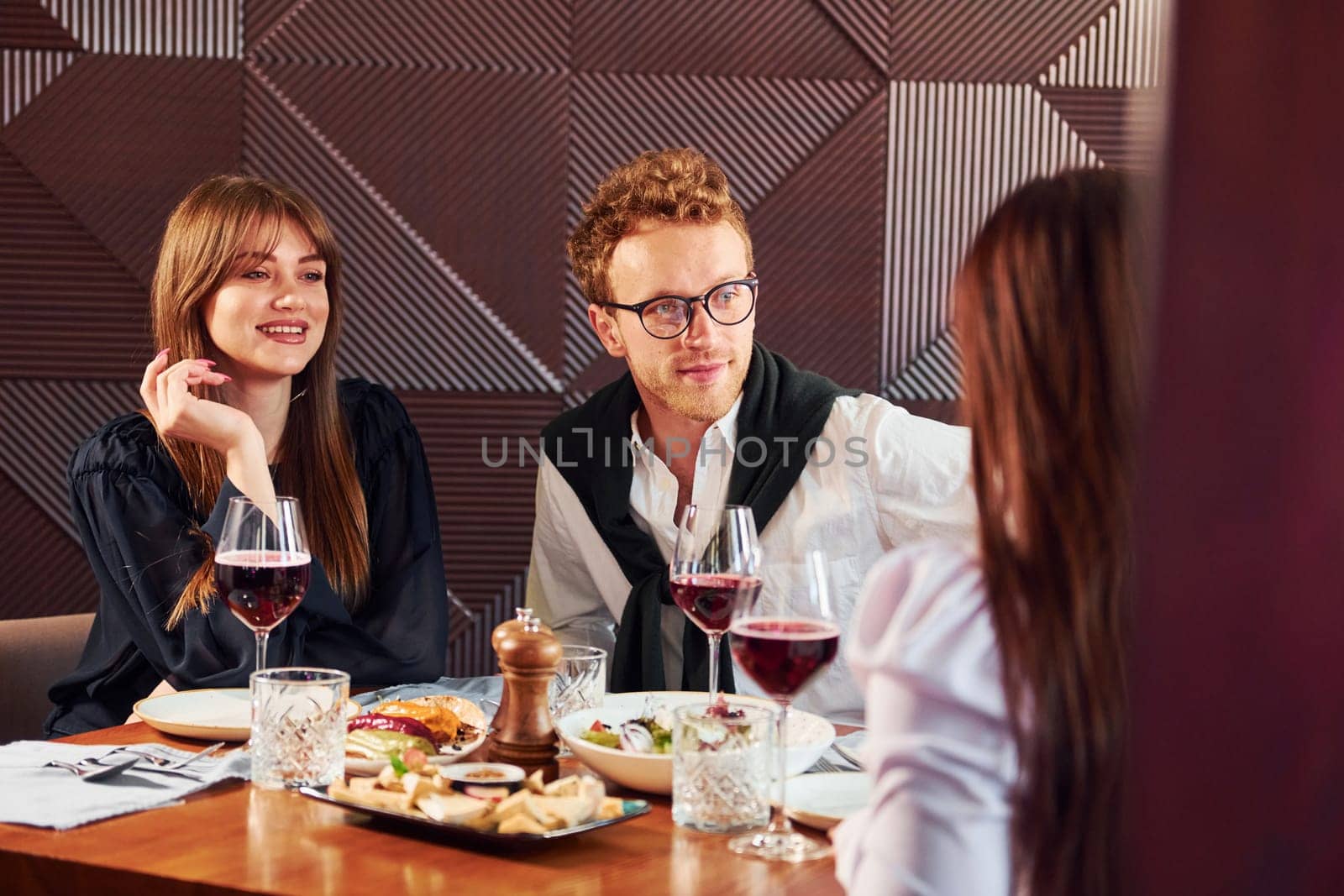 Having conversation. Indoors of new modern luxury restaurant by Standret