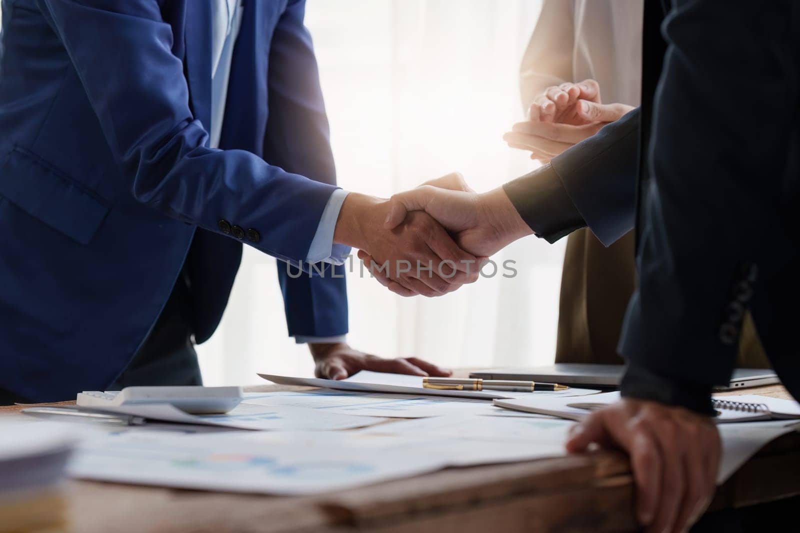 Business people handshake. Successful businessmen handshaking after good deal. Finishing up meeting concept by itchaznong