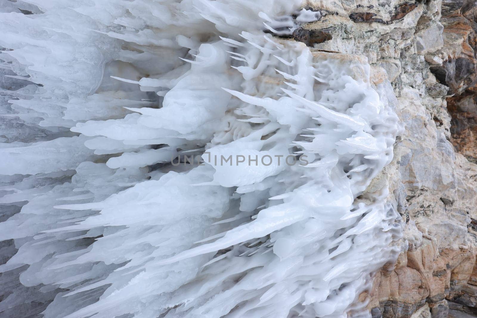 White ice hangs in long drops in a cave on Lake Baikal