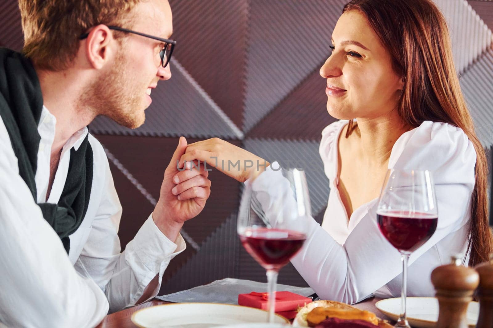 Couple of young guy and adult woman. Indoors of new modern luxury restaurant.