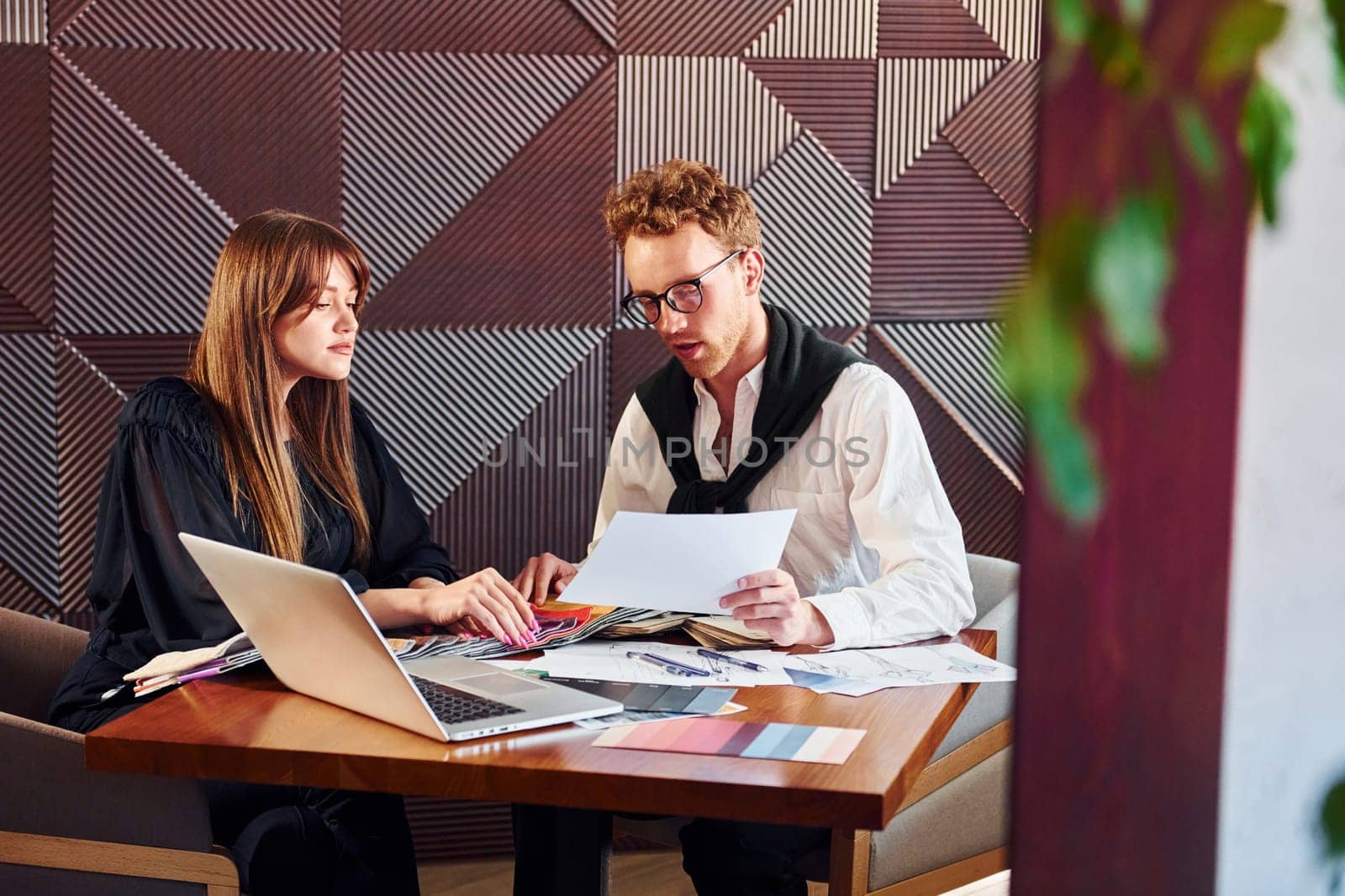 Business people working with documents. Indoors of new modern luxury restaurant.