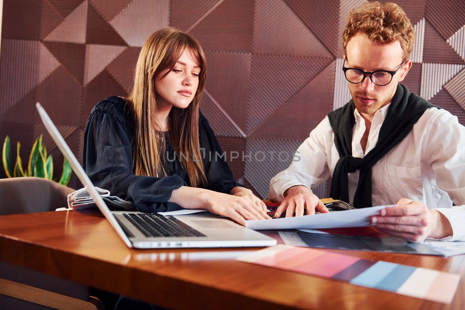 Business people working with documents. Indoors of new modern luxury restaurant.