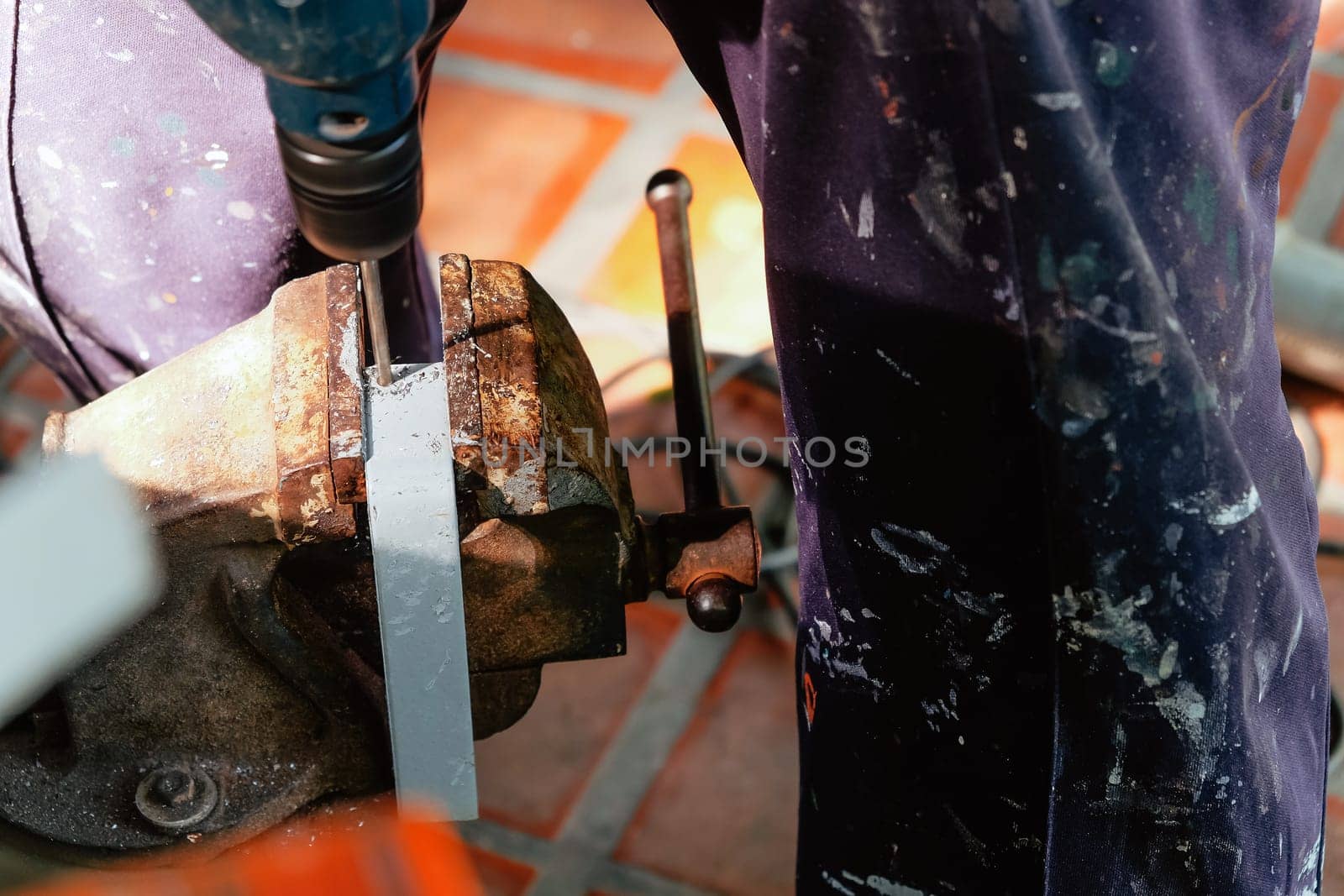 Metalworker working on a drilling machine by ponsulak
