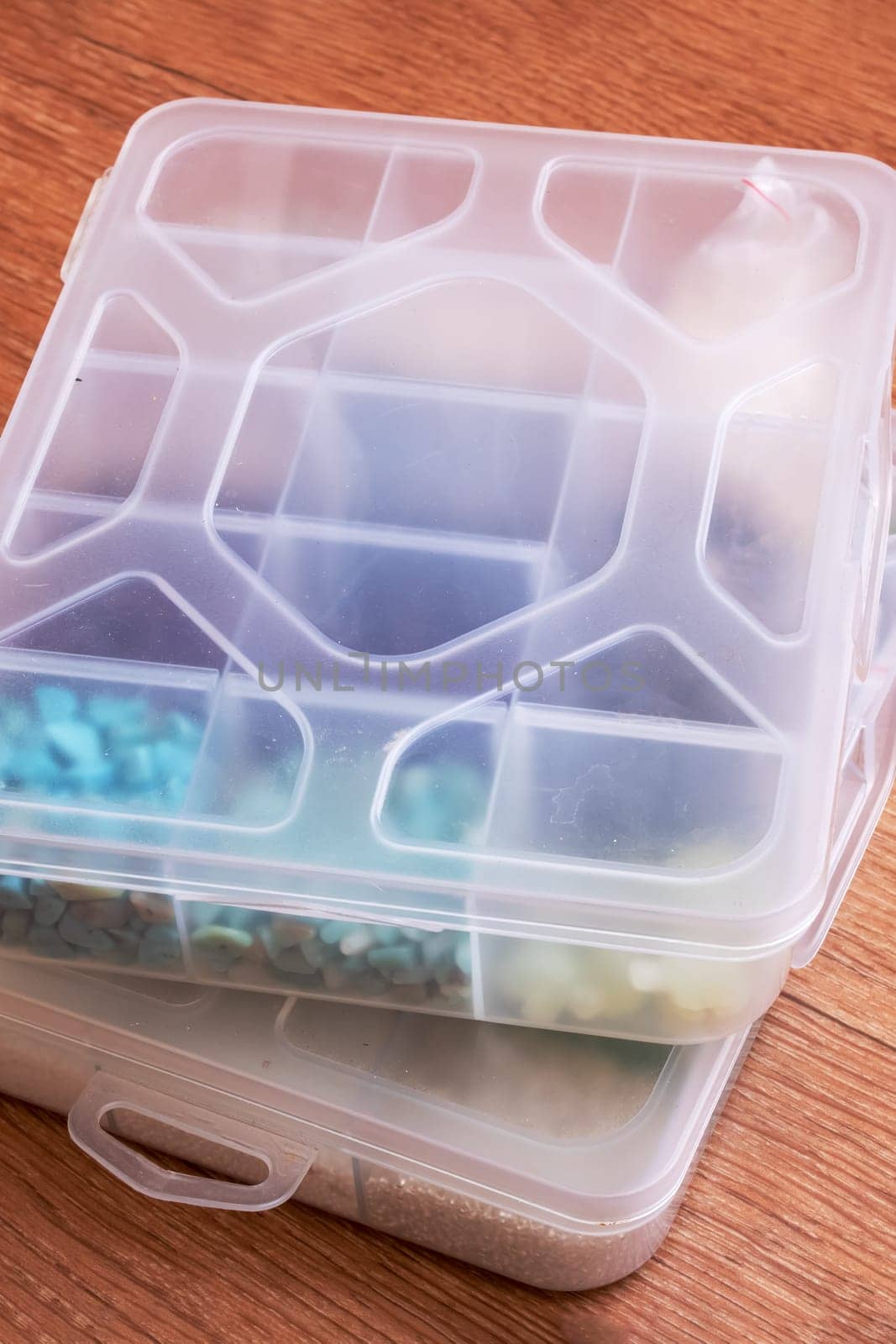 Small storage containers on a wooden floor close up