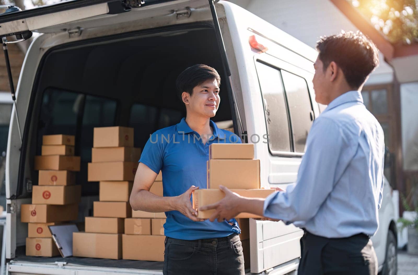 Home delivery service and working service mind. Man customer hand receiving a cardboard boxes parcel from delivery service courier. delivery logistic concept by nateemee