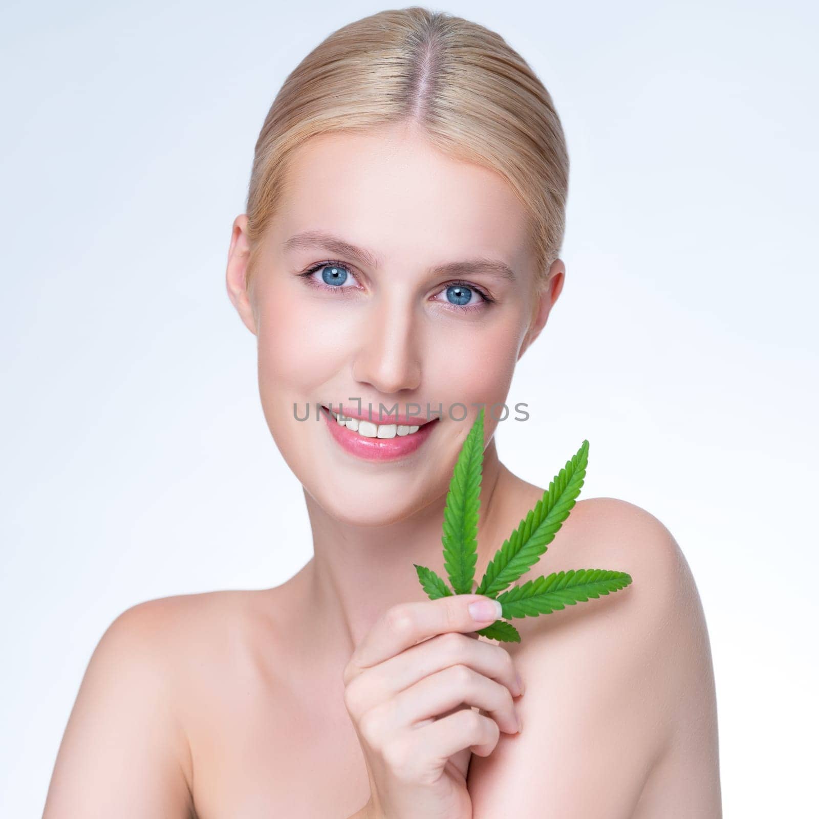 Closeup personable woman hold green leaf as cannabis beauty concept. by biancoblue
