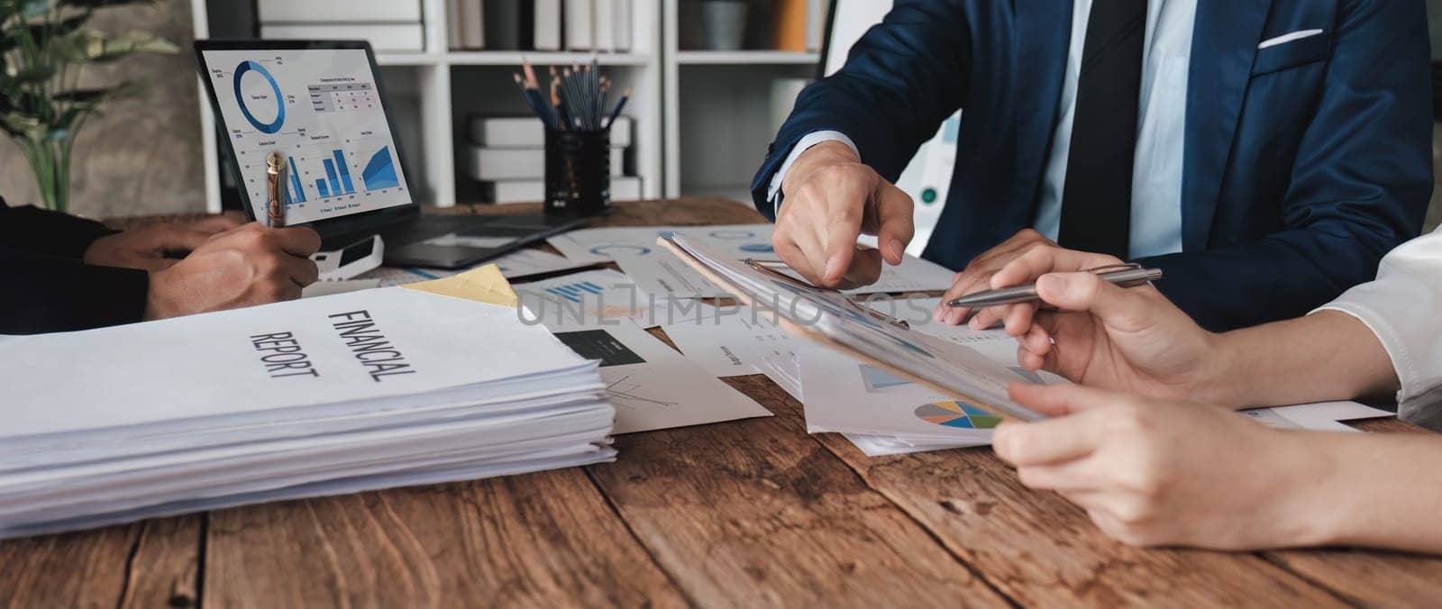 Business People Meeting using laptop computer,calculator,notebook,stock market chart paper for analysis Plans to improve quality next month. Conference Discussion Corporate Concept....