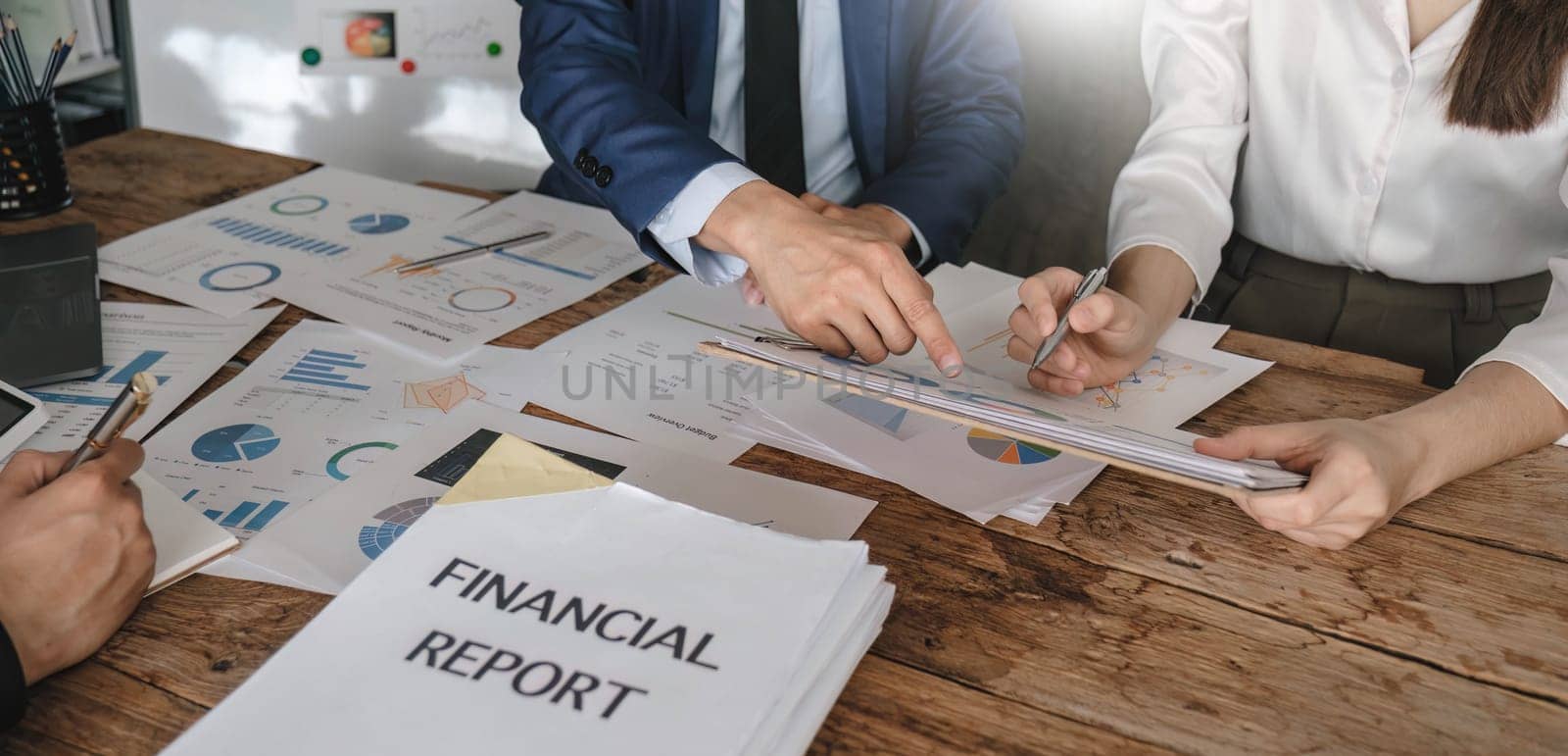 Business People Meeting using laptop computer,calculator,notebook,stock market chart paper for analysis Plans to improve quality next month. Conference Discussion Corporate Concept.. by wichayada