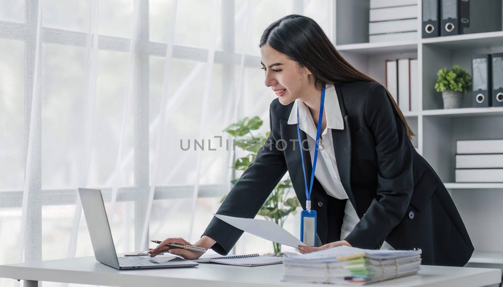 Business woman using calculator for do math finance on wooden desk in office and business working background, tax, accounting, statistics and analytic research concept.. by wichayada