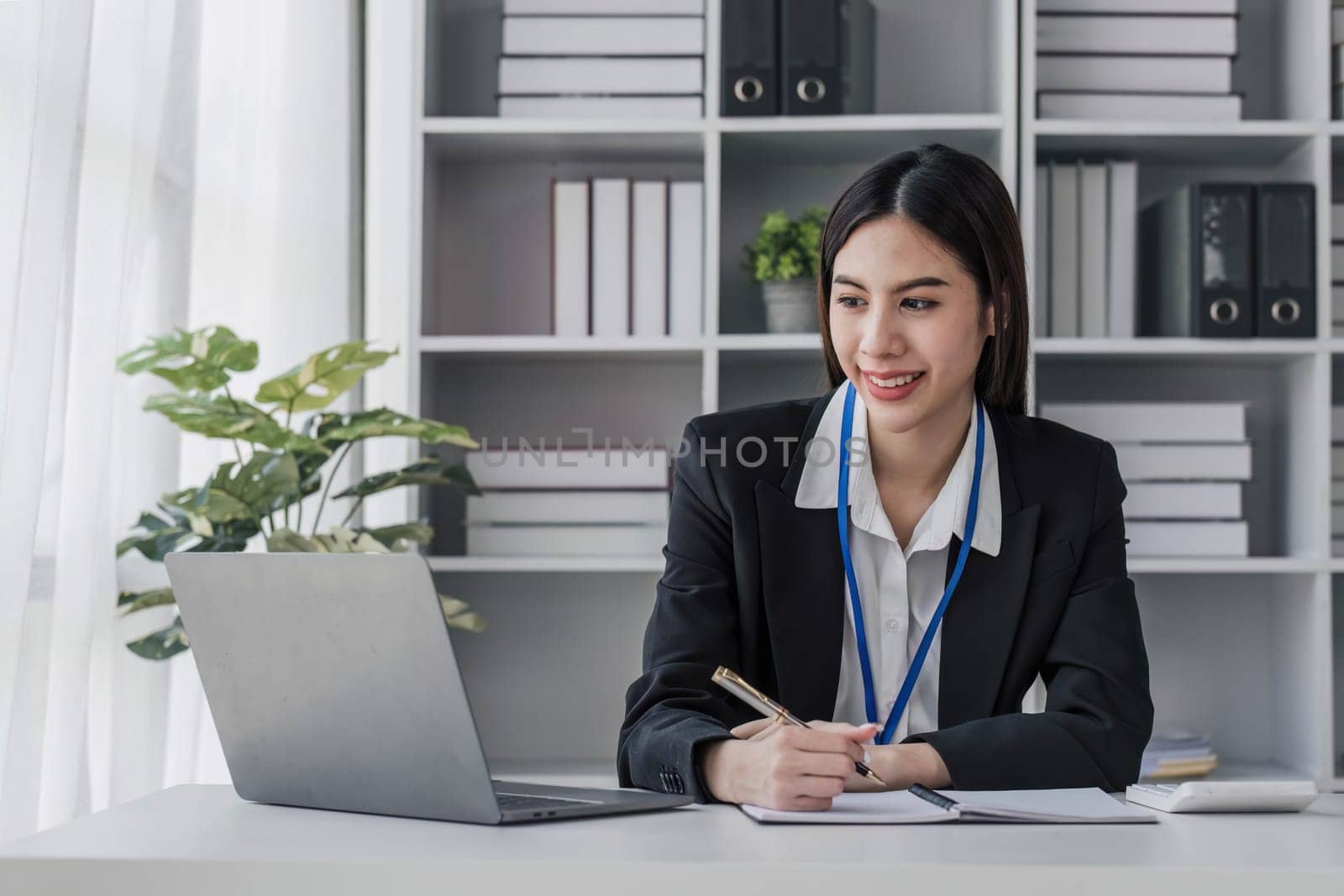 Business woman using calculator for do math finance on wooden desk in office and business working background, tax, accounting, statistics and analytic research concept.. by wichayada
