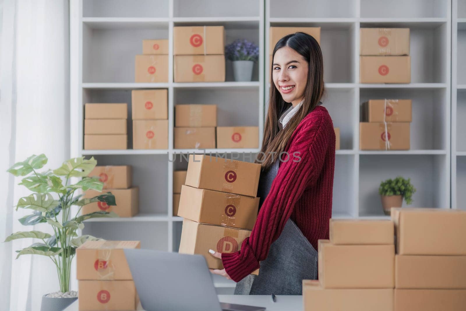 Startup small business entrepreneur SME, asian woman packing cloth in box. Portrait young Asian small business owner home office, online sell marketing delivery, SME e-commerce telemarketing concept. by wichayada