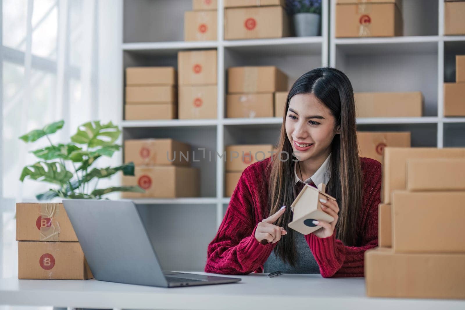 Startup small business entrepreneur SME, asian woman packing cloth in box. Portrait young Asian small business owner home office, online sell marketing delivery, SME e-commerce telemarketing concept...