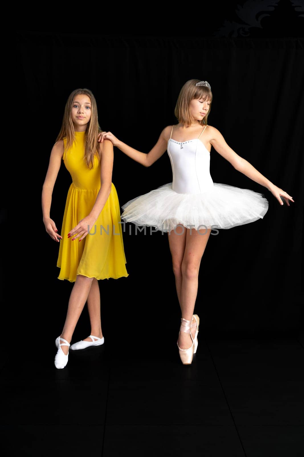 teenage ballerinas in the studio, portrait on a black background. High quality photo