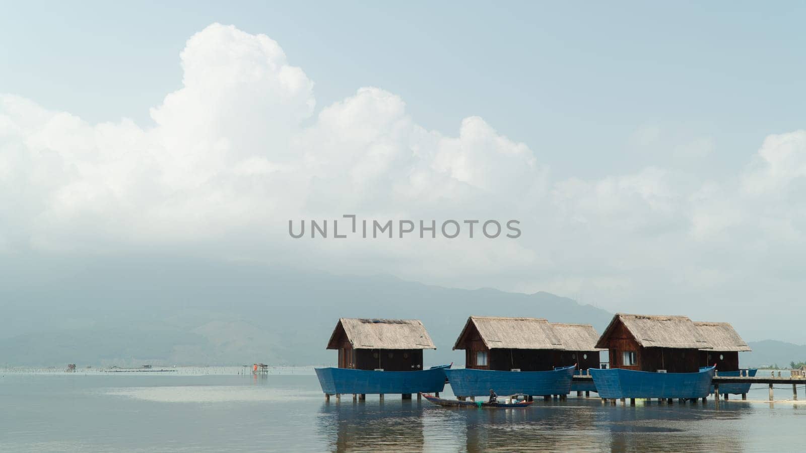 Blue fishing accommodation in the river against the background of the sky and clouds. High quality photo