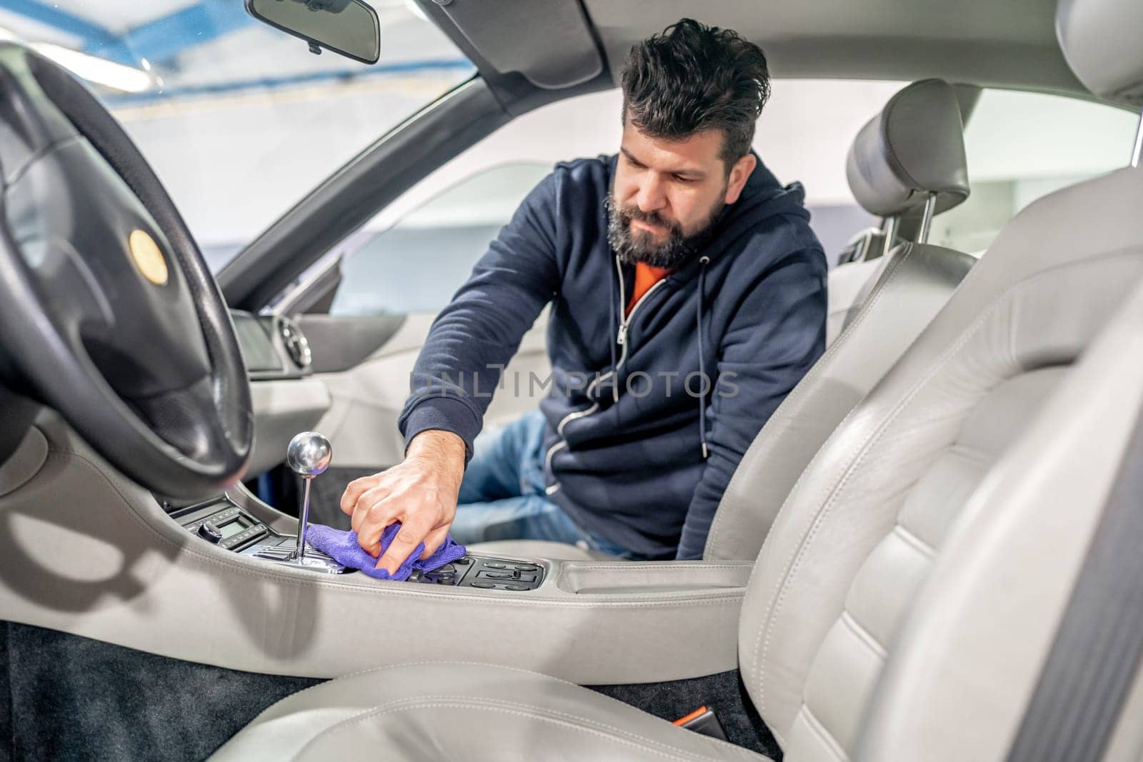 manual cleaning and polishing of luxury car interiors with a microfiber. High quality photo