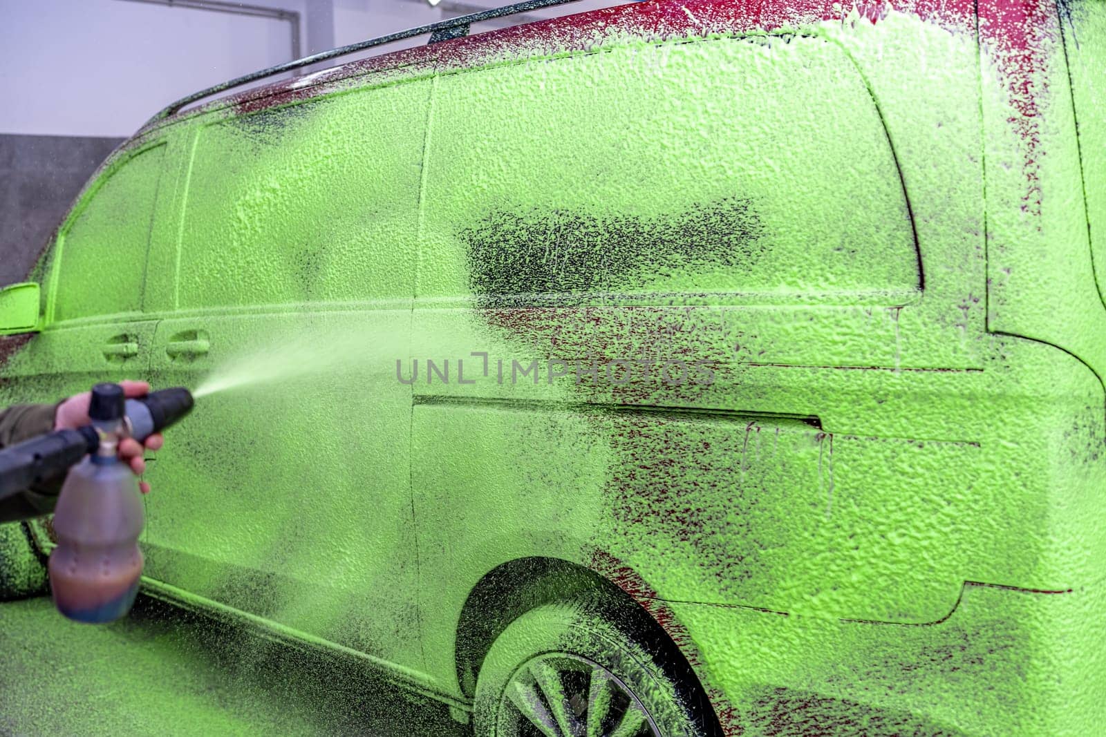 wash cars with green active foam in the garage. High quality photo