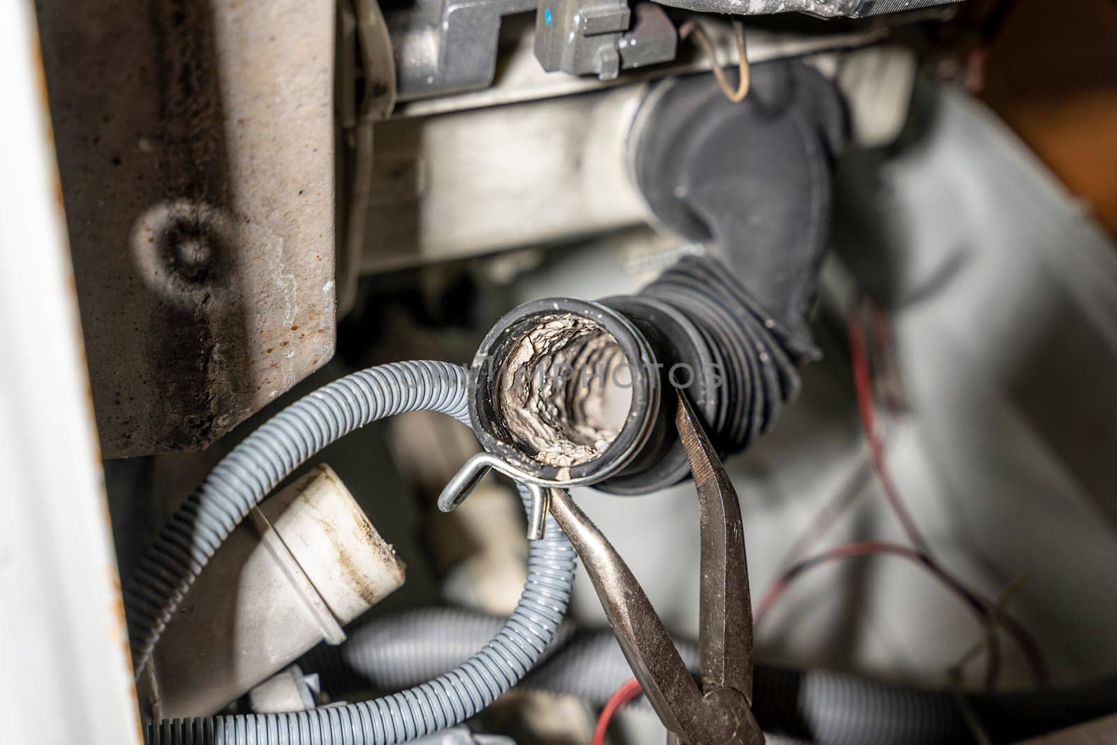 cleaning and repair of a used washing machine from scale and deposits. Blockage. The water pump and rubber hoses are clogged with sediments. A jammed pump. calcium-magnesium deposits. Scum