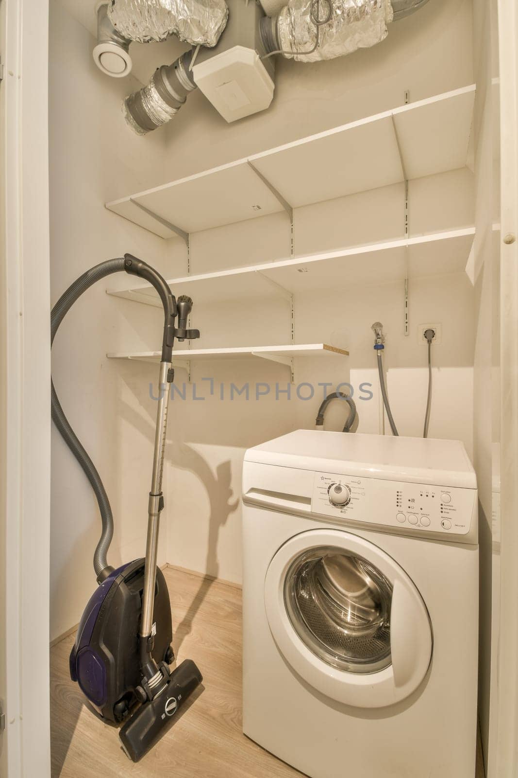 a washer and dryer in a laundry room by casamedia