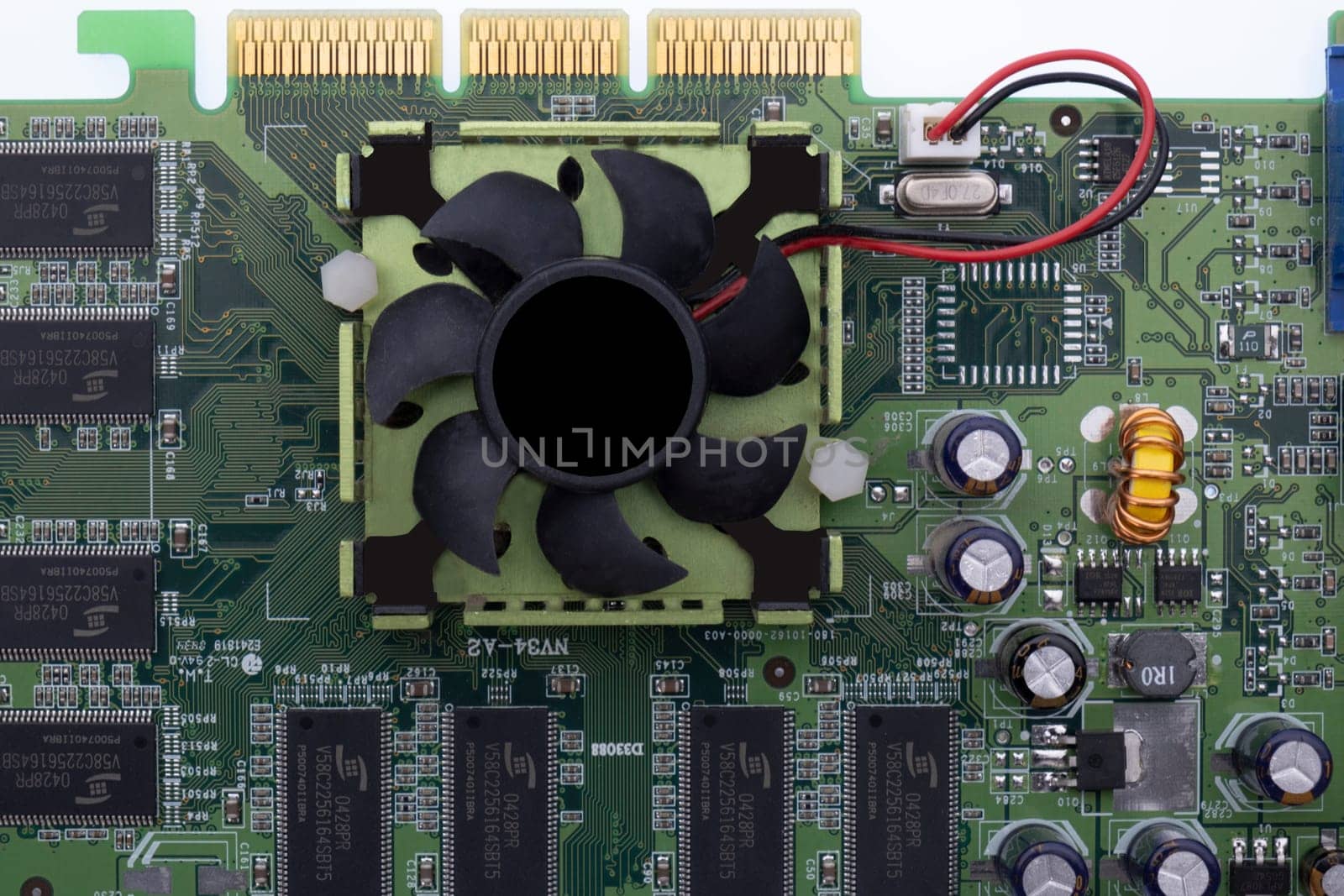 Close up of a graphics card, circuit board with cooling fan, circuits, wiring. High quality photo