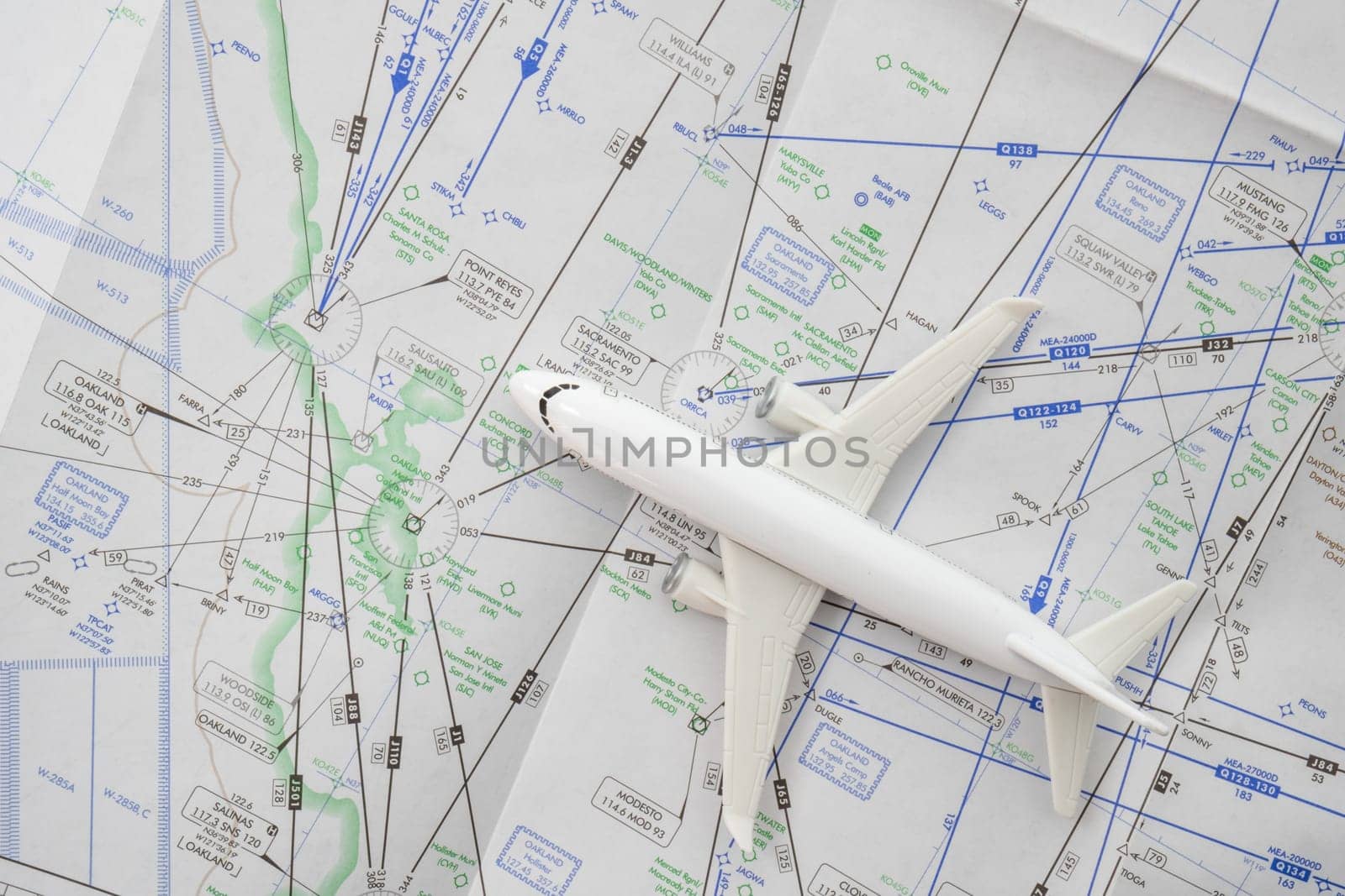 Close up of a miniature airplane on an FAA aviation sectional navigation map showing Oakland airport approach. High quality photo