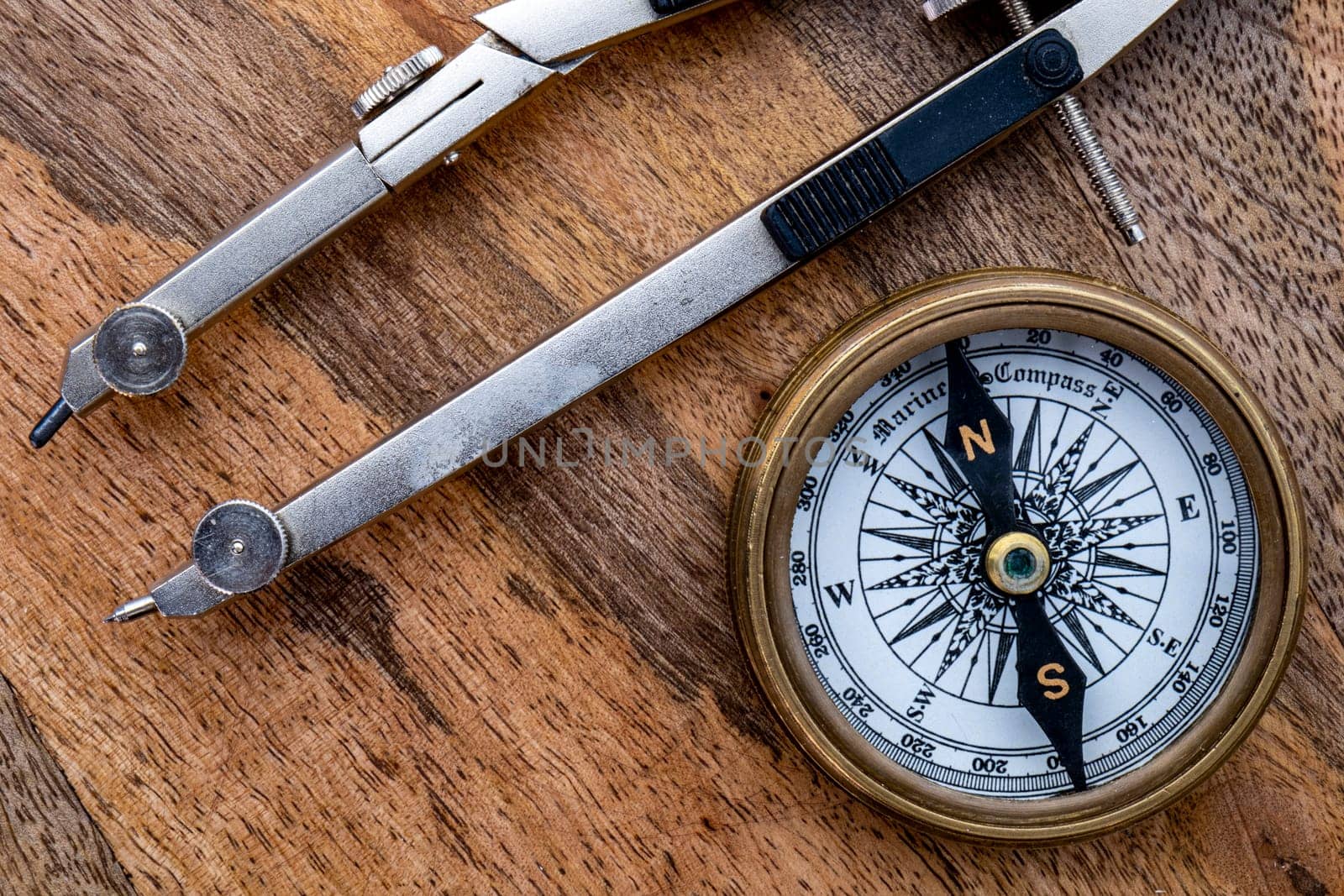 Directional compass drawing compass on wooden surface. High quality photo