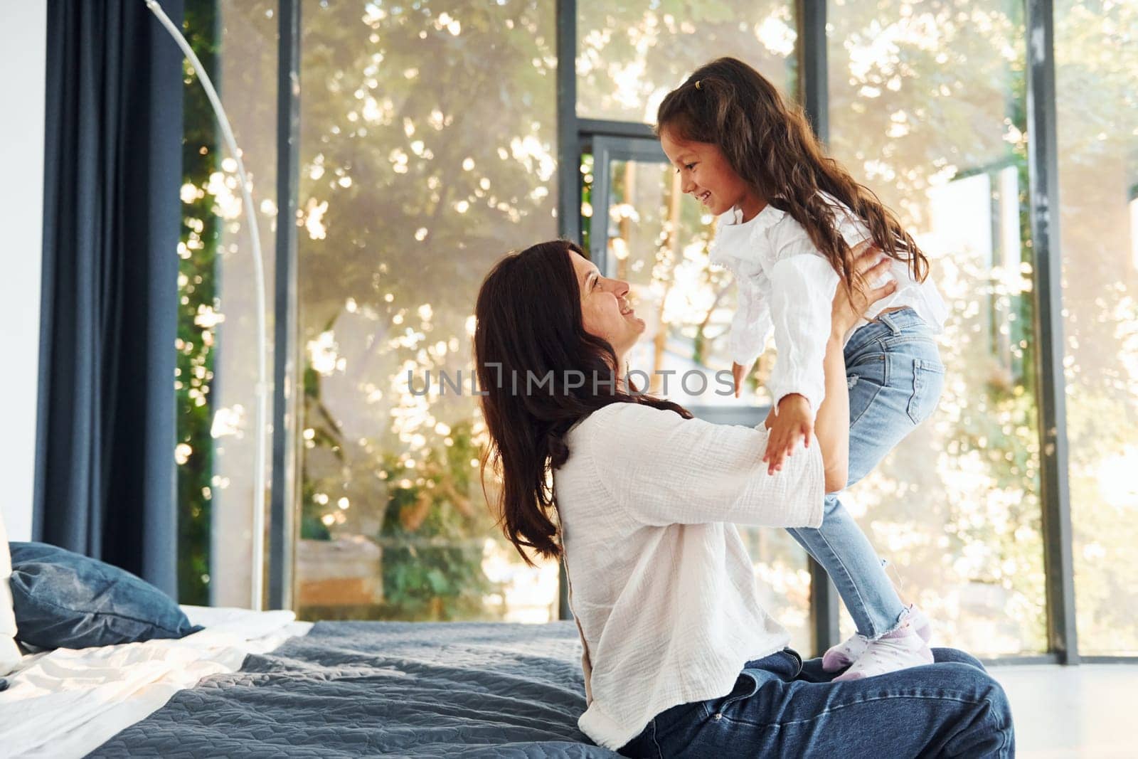 Love of child and parent. Mother and her daughter spending time together at home.