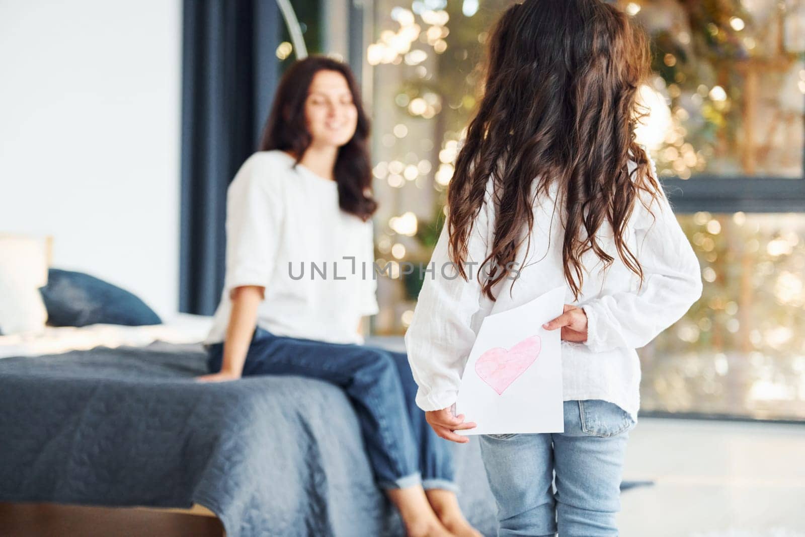 Surprise for mother. Woman and her daughter spending time together at home.