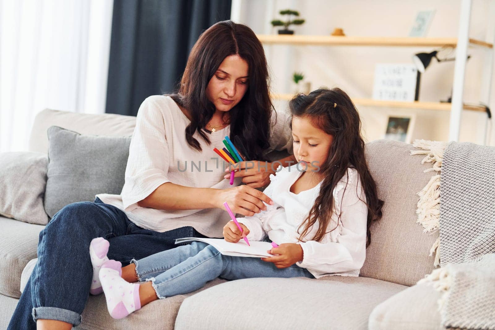 Modern design. Mother and her daughter spending time together at home.