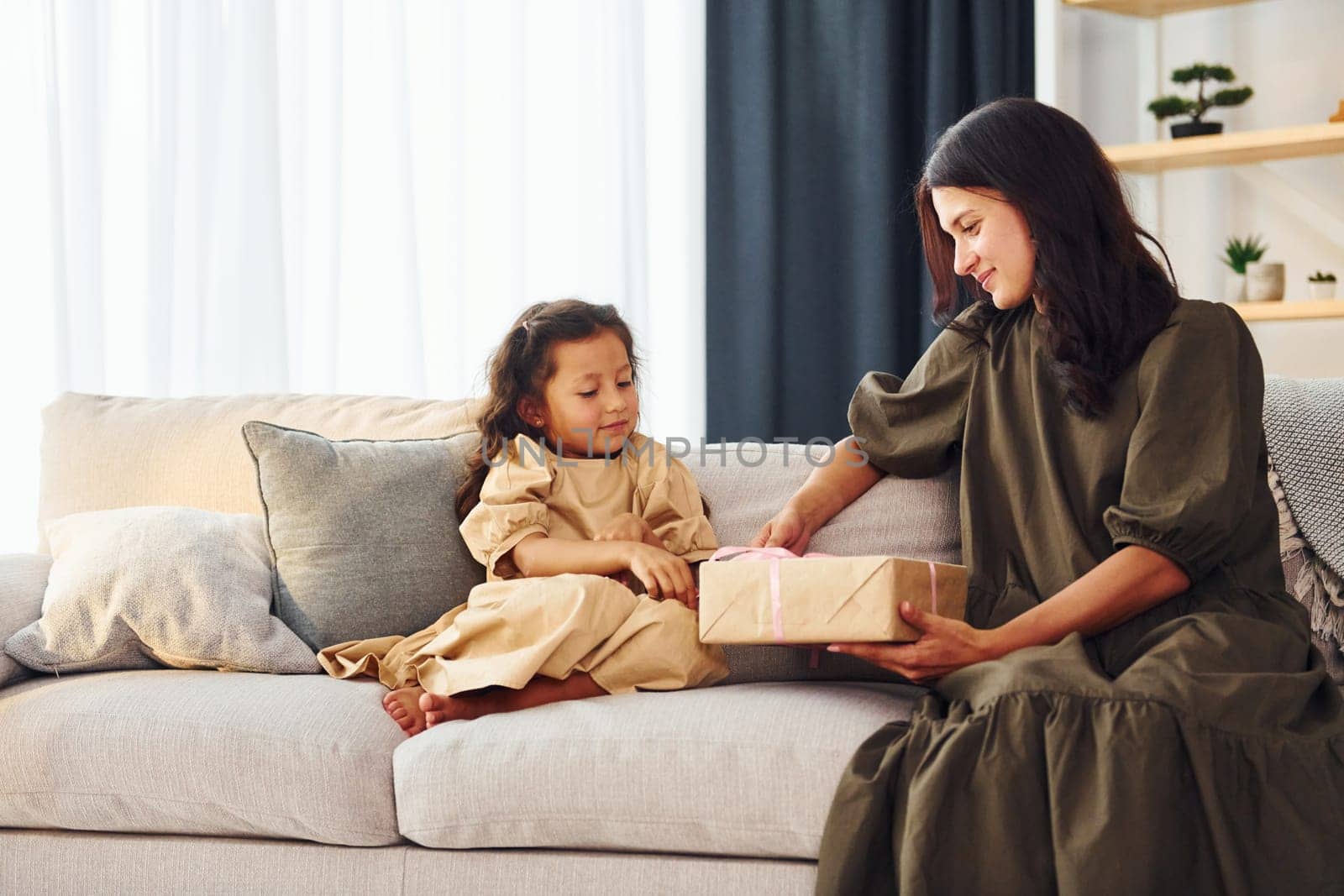 Conception of parent love. Mother and her daughter spending time together at home.